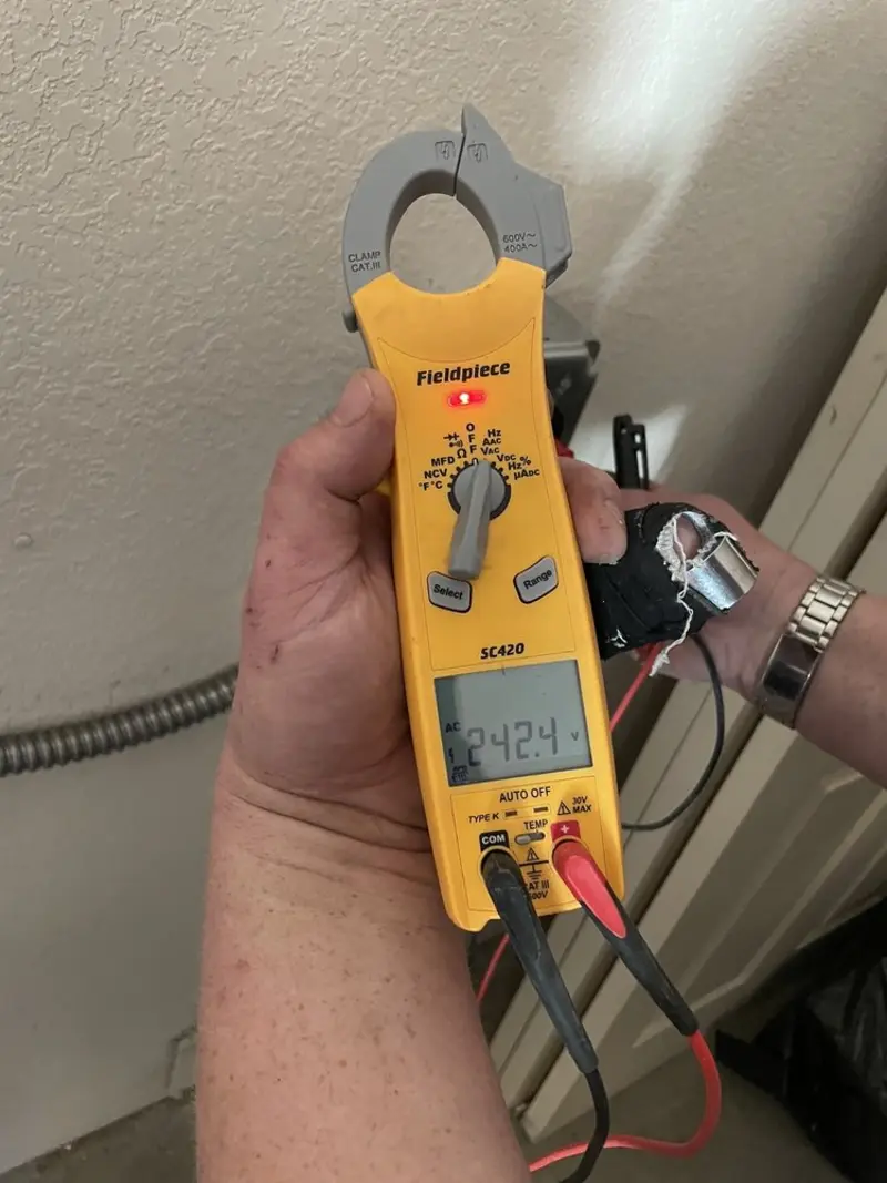 Voltage testing with clamp meter during Outlet Installation in Clinton